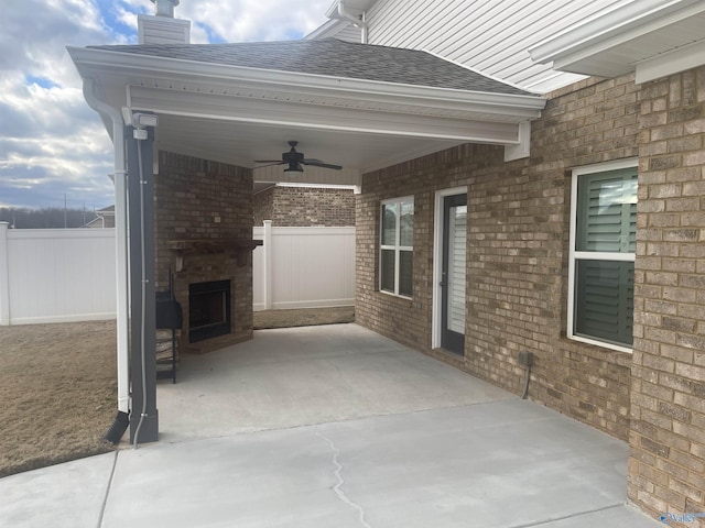 view of patio with ceiling fan and a fireplace