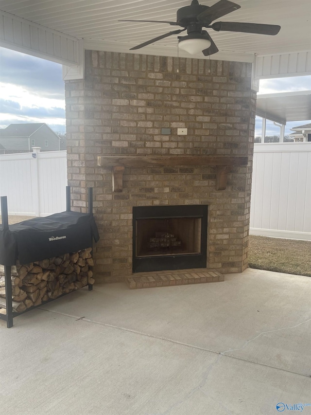 view of patio with ceiling fan and a fireplace