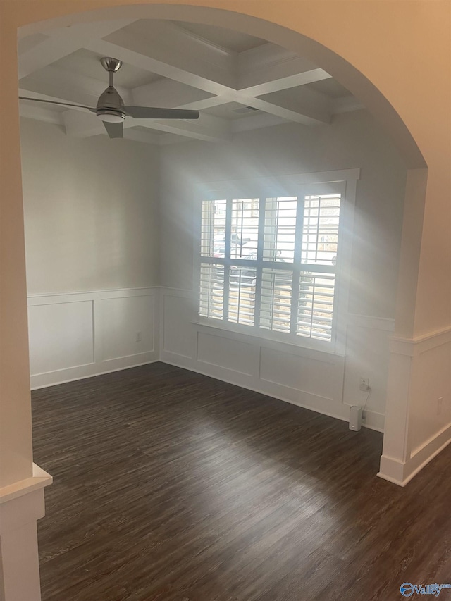 spare room featuring ceiling fan, dark hardwood / wood-style floors, beam ceiling, and coffered ceiling