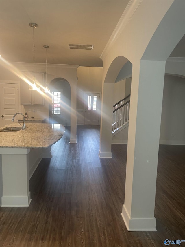 hall with dark hardwood / wood-style flooring, crown molding, and sink