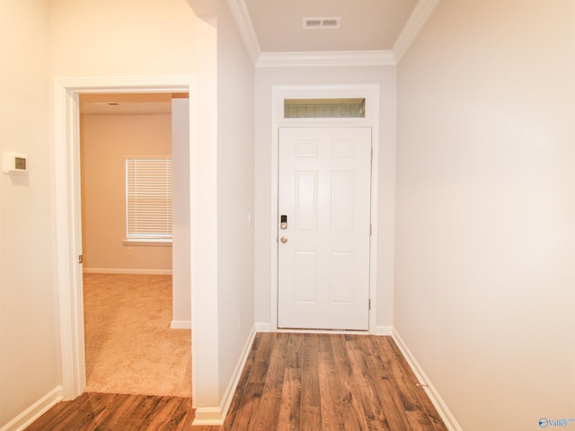 doorway to outside featuring ornamental molding and dark wood-type flooring