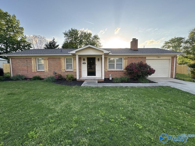ranch-style house with an attached garage, brick siding, driveway, and a front lawn