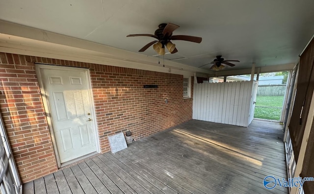 unfurnished sunroom with ceiling fan