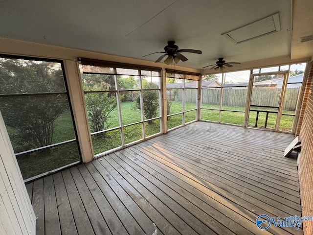 unfurnished sunroom featuring a wealth of natural light and ceiling fan