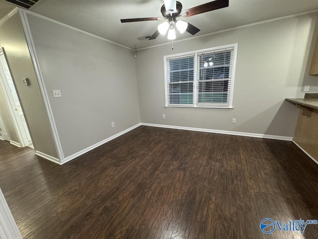 unfurnished room with dark wood-style flooring, crown molding, baseboards, and a ceiling fan