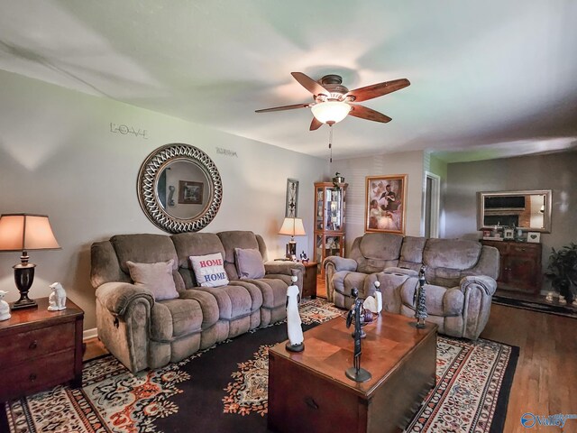 living room featuring a ceiling fan and wood finished floors