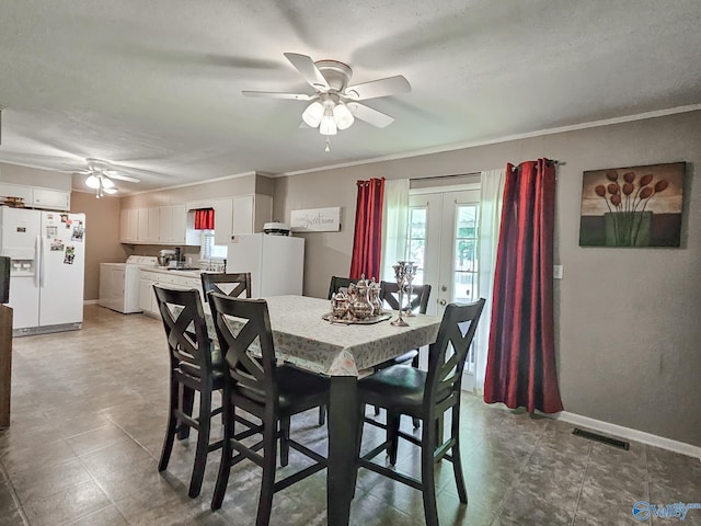 dining area with separate washer and dryer, visible vents, french doors, and ornamental molding