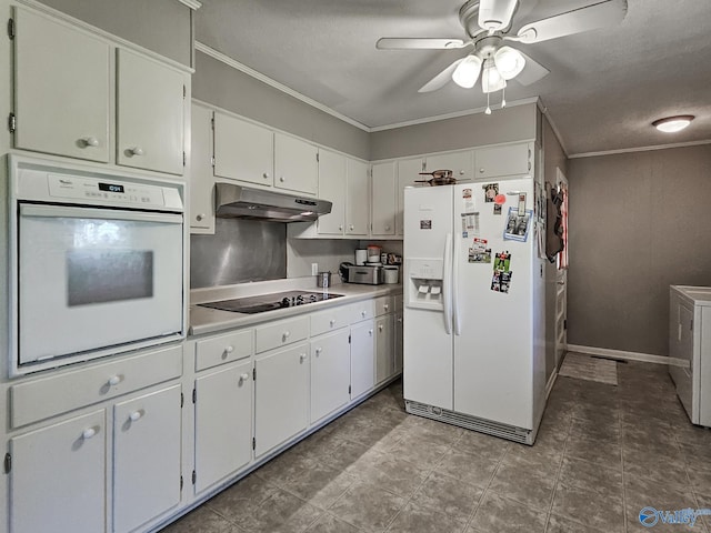 kitchen with under cabinet range hood, light countertops, ornamental molding, white appliances, and washer / clothes dryer