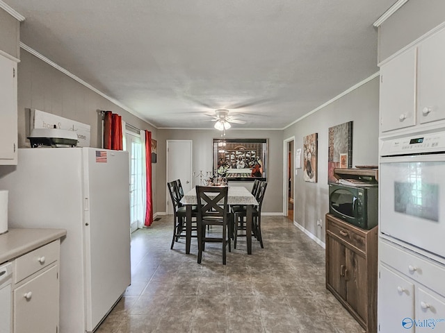 dining room featuring crown molding, baseboards, and ceiling fan