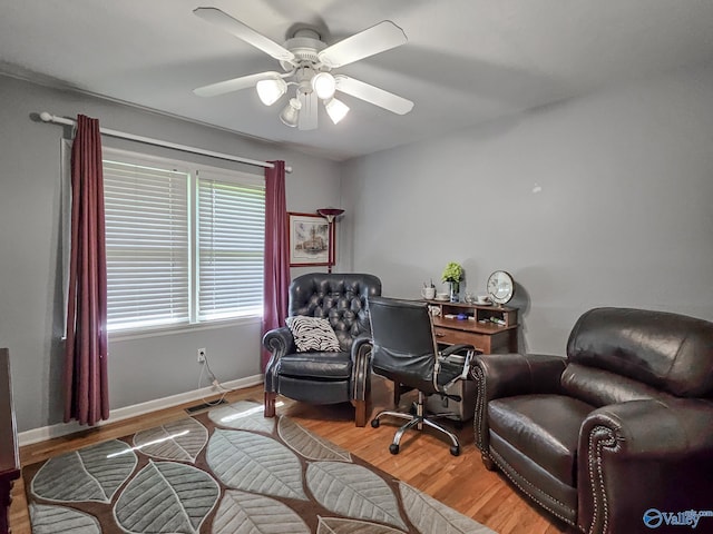 office area featuring light wood-style flooring, baseboards, and a ceiling fan