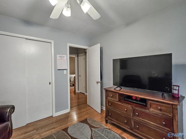 bedroom with a closet, ceiling fan, and light wood-style floors