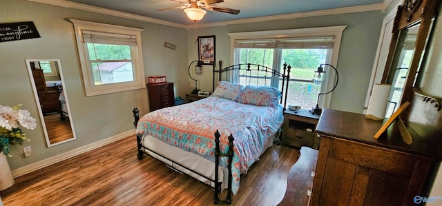 bedroom with ceiling fan, dark hardwood / wood-style flooring, and multiple windows