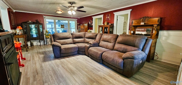 living room with ceiling fan, crown molding, and light hardwood / wood-style floors