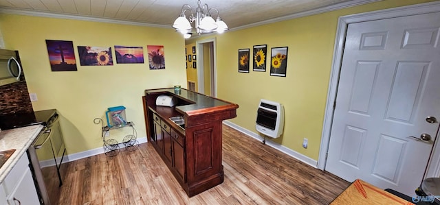 interior space featuring light wood-type flooring, crown molding, heating unit, and a notable chandelier