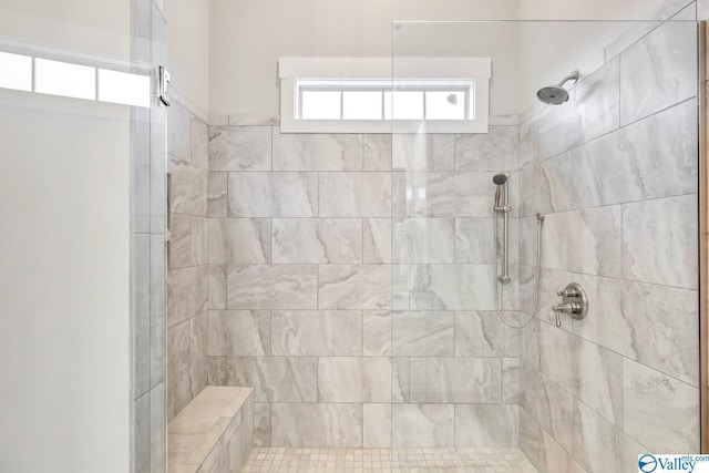 bathroom with a tile shower