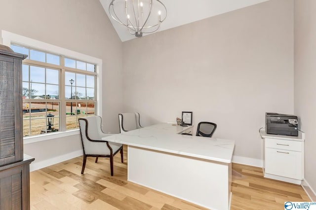 office area with vaulted ceiling, a chandelier, and light hardwood / wood-style flooring