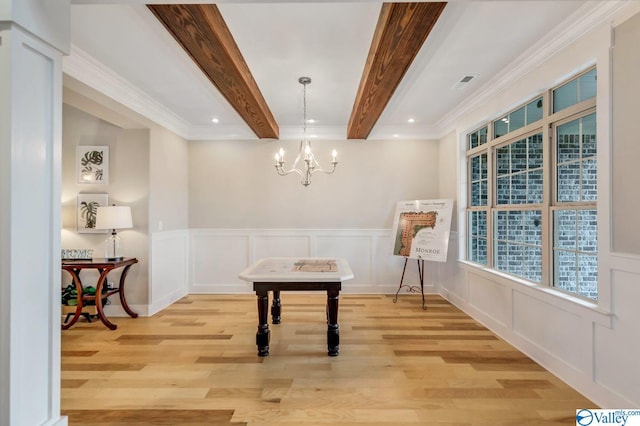 miscellaneous room featuring beamed ceiling, an inviting chandelier, and light hardwood / wood-style flooring