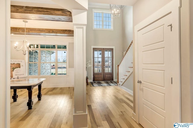 entryway featuring a chandelier, light hardwood / wood-style flooring, and a wealth of natural light