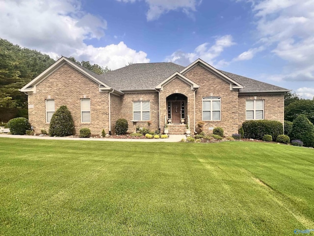 2701 Arbor Oak Dr SE, Owens Cross Roads, AL 35763 - view of front of house featuring brick siding, a front lawn, and roof with shingles