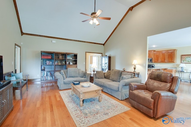 2701 Arbor Oak Dr SE, Owens Cross Roads, AL 35763 - living area with high vaulted ceiling, ceiling fan, ornamental molding, light wood-style flooring, and baseboards