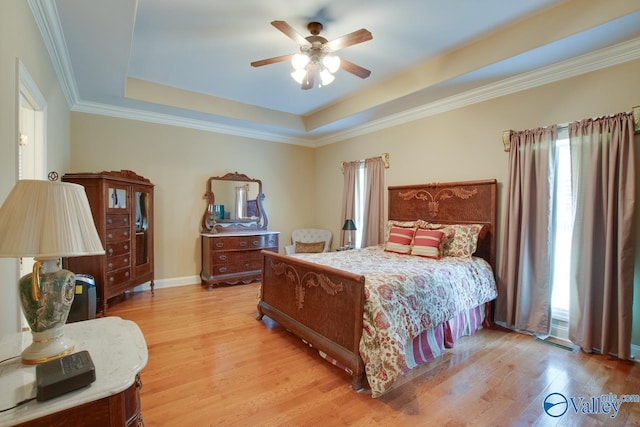 2701 Arbor Oak Dr SE, Owens Cross Roads, AL 35763 - bedroom with a raised ceiling, light wood finished floors, ceiling fan, and ornamental molding