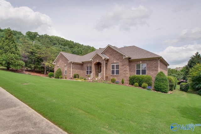 2701 Arbor Oak Dr SE, Owens Cross Roads, AL 35763 - view of front of home featuring brick siding, a front lawn, and a shingled roof