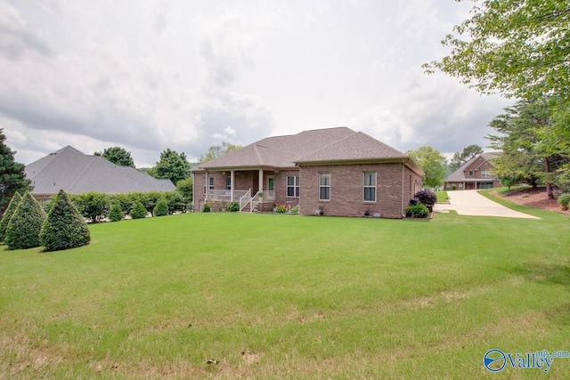 2701 Arbor Oak Dr SE, Owens Cross Roads, AL 35763 - back of property with brick siding, covered porch, a lawn, and a shingled roof