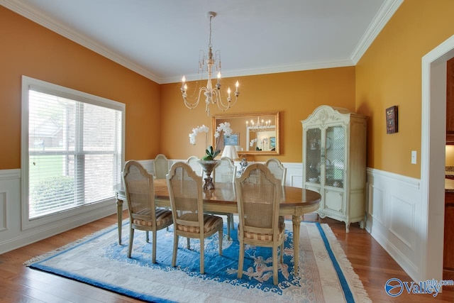 2701 Arbor Oak Dr SE, Owens Cross Roads, AL 35763 - dining space with a chandelier, crown molding, wood finished floors, and wainscoting