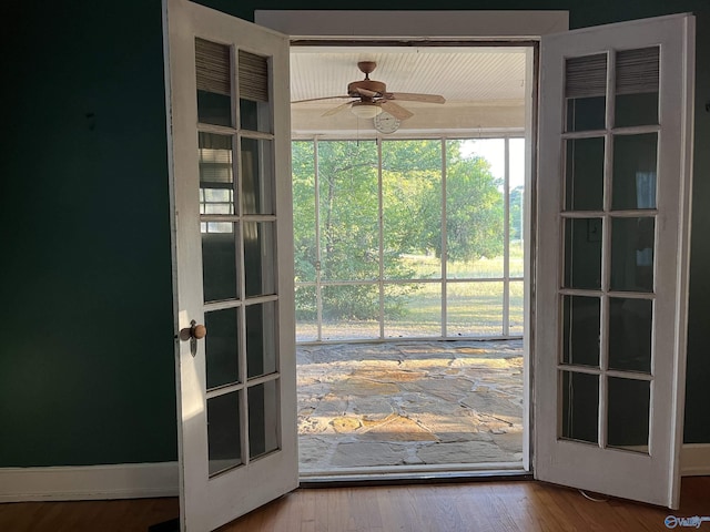 doorway to outside featuring ceiling fan and wood finished floors