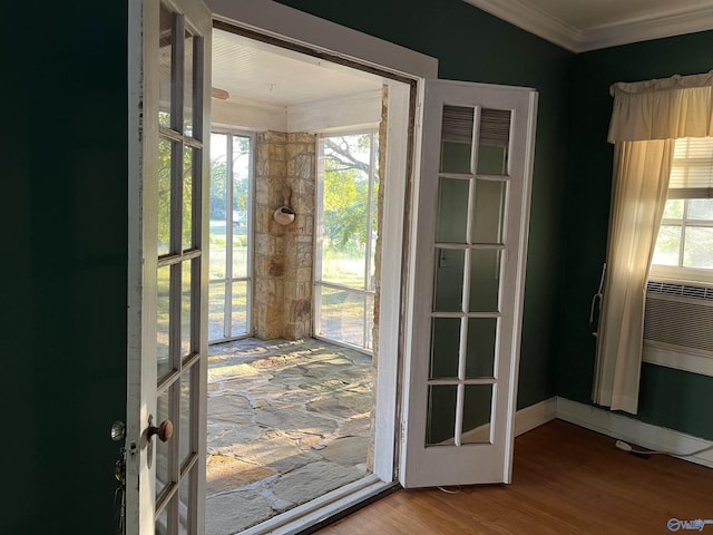 doorway featuring french doors, a healthy amount of sunlight, crown molding, and wood finished floors