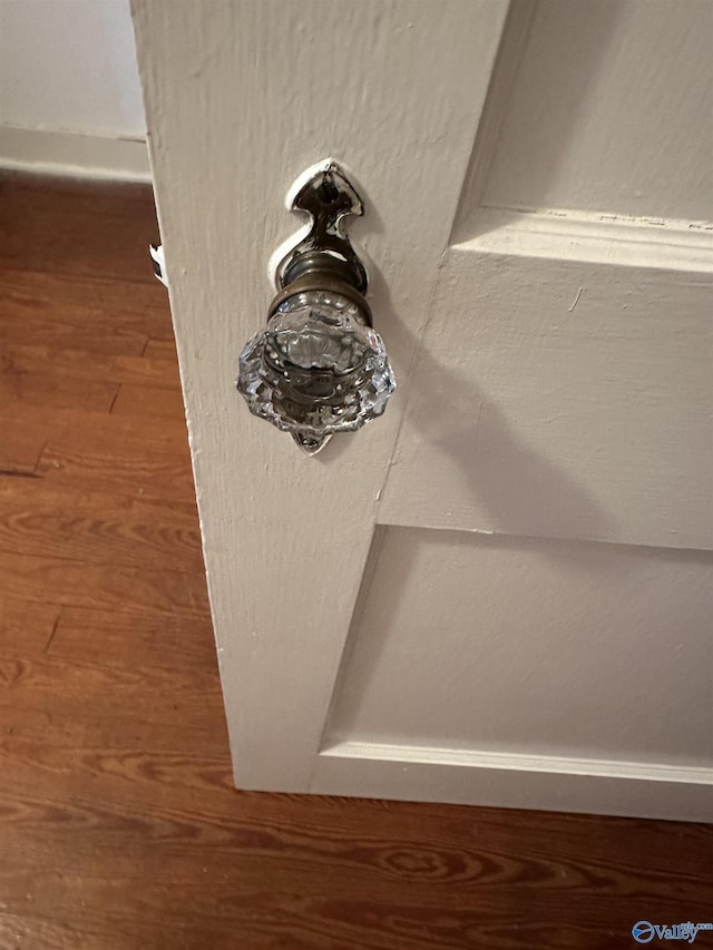 room details with baseboards and wood finished floors