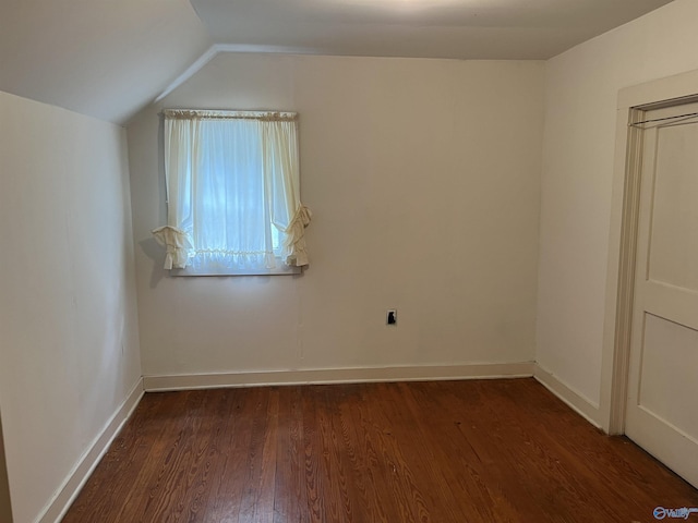 additional living space featuring lofted ceiling, baseboards, and wood finished floors