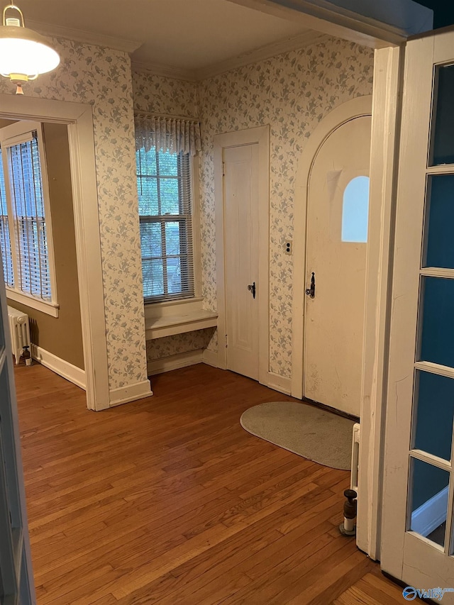 entryway with baseboards, radiator heating unit, wood finished floors, and wallpapered walls
