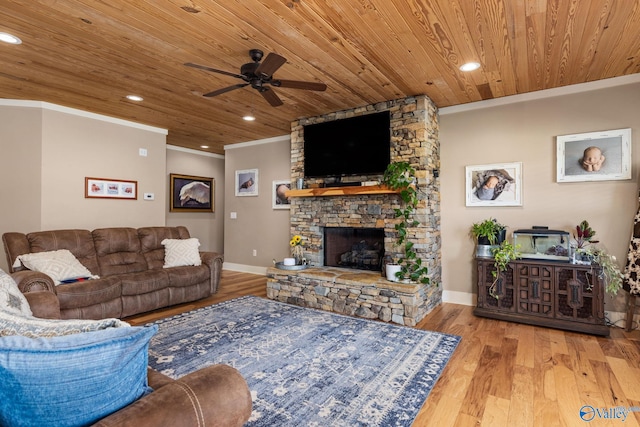 living room featuring crown molding, wood ceiling, a ceiling fan, a fireplace, and wood finished floors