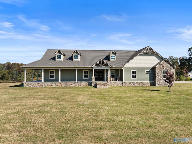 view of front of house with a porch, a front lawn, and metal roof