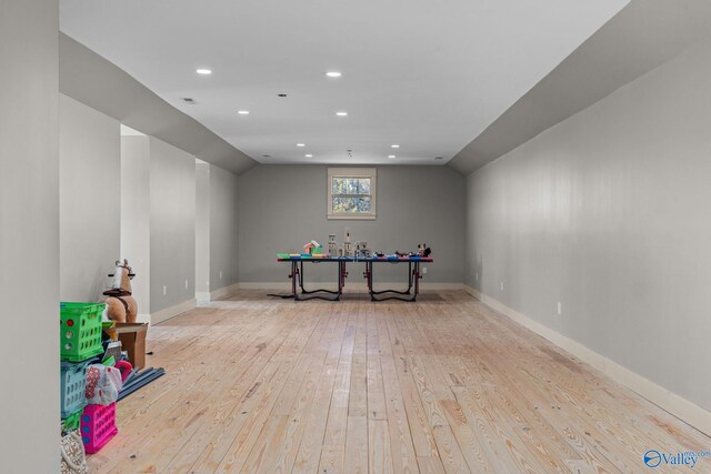 playroom with baseboards, lofted ceiling, recessed lighting, and light wood finished floors