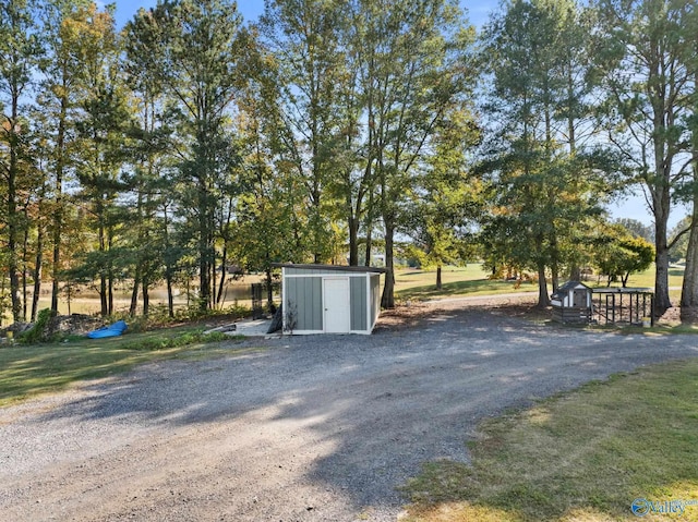 exterior space featuring an outdoor structure and a shed