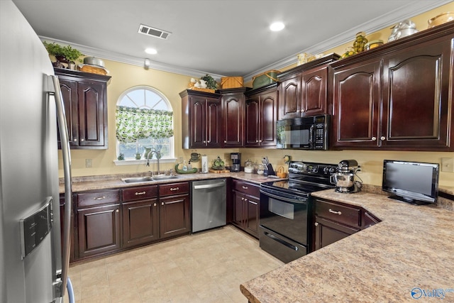 kitchen featuring crown molding, visible vents, black appliances, light countertops, and a sink