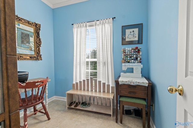 sitting room featuring crown molding, baseboards, and plenty of natural light
