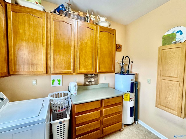 clothes washing area featuring washer / dryer, cabinets, water heater, and light tile patterned flooring