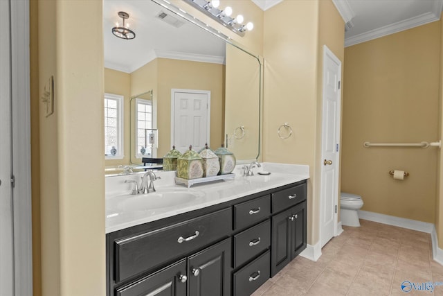 bathroom featuring toilet, a sink, ornamental molding, and visible vents