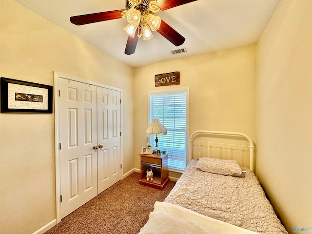 bedroom with dark carpet, a closet, and ceiling fan