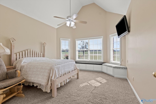 bedroom featuring radiator, light colored carpet, multiple windows, and high vaulted ceiling