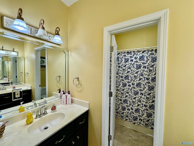 bathroom featuring vanity, a shower with shower curtain, and tile patterned floors