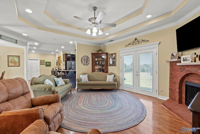 living room with recessed lighting, french doors, ceiling fan, and a raised ceiling