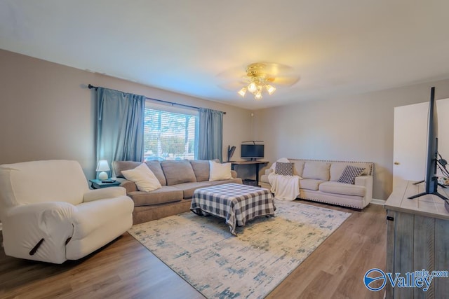 living room with hardwood / wood-style flooring and ceiling fan