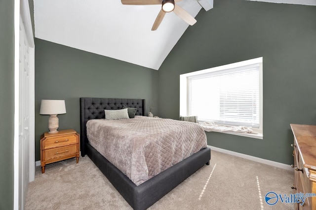 bedroom with light carpet, baseboards, vaulted ceiling, and a ceiling fan