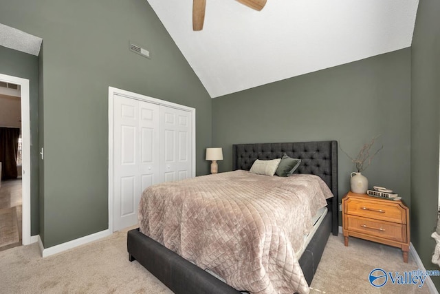 bedroom with a closet, visible vents, light carpet, and baseboards