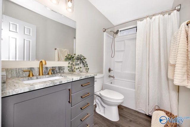 bathroom with toilet, shower / tub combo, wood finished floors, and vanity