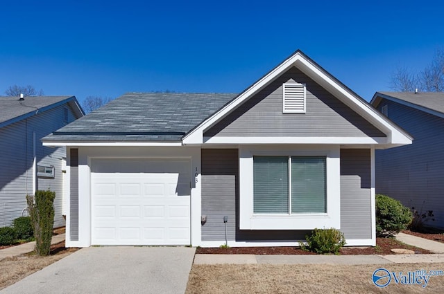 view of front of house featuring concrete driveway, roof with shingles, and an attached garage